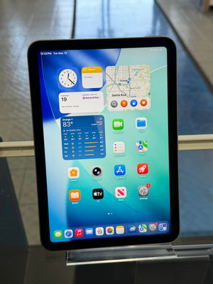 Tablet with a colorful display of app icons on a reflective surface