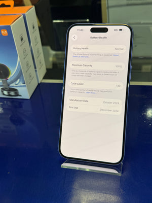 Smartphone displaying battery health information on a blue surface with a box in the background