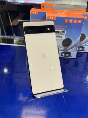 Smartphone with Google logo on a blue surface with product packaging in the background