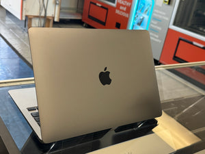 Apple laptop on a glass surface 