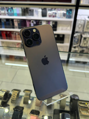 Smartphone with Apple logo on a reflective surface in a store setting