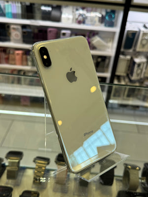 Silver iPhone X on display with blurred store interior background