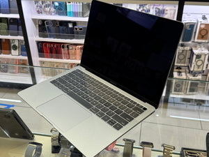 Laptop on display in a store with shelves in the background