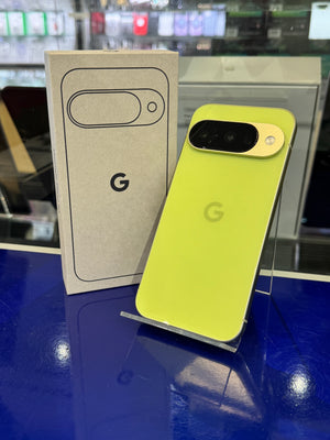 Yellow smartphone and packaging with Google logo on a blue surface