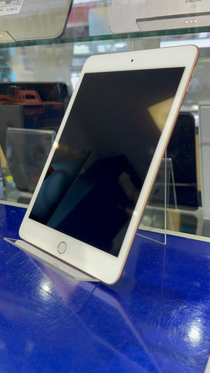 Tablet device on a blue surface with a blurred background