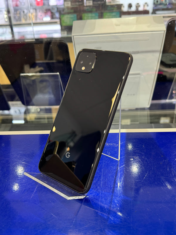 Black smartphone on a reflective surface with a blue background
