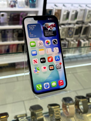 Smartphone with app icons displayed on a stand in a store setting