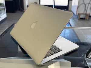 Laptop with Apple logo on a glass surface