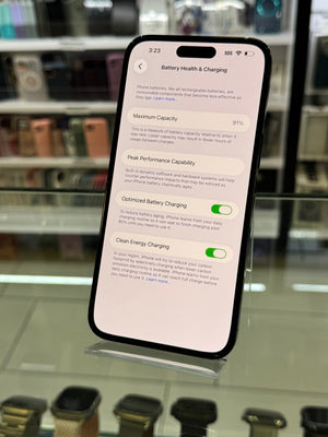 Smartphone displaying battery health and charging settings on a blurred background
