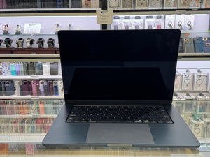 Laptop on display in a store with shelves in the background