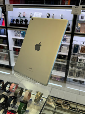 Apple iPad on display in a store with watches below