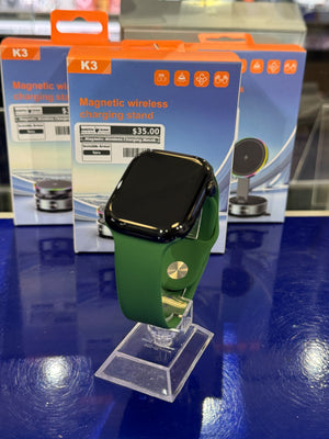 Smartwatch with green leather strap on a blue display stand
