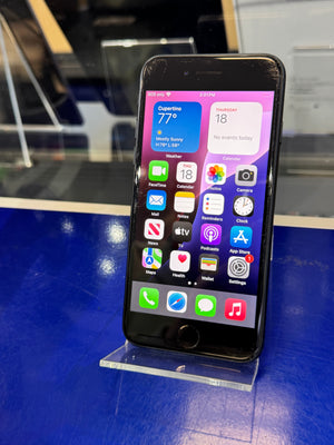 Smartphone with app icons displayed on a stand against a blue background