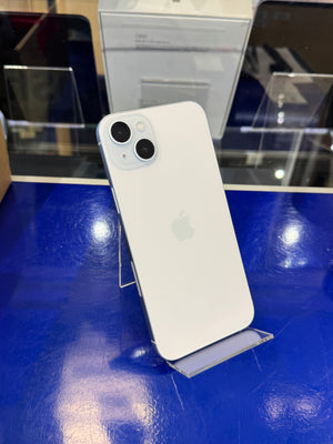 White smartphone on a blue surface with blurred background
