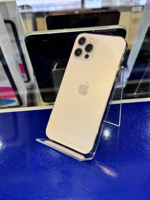 An Apple iPhone in white color, shown from the back on a clear display stand next to a blue surface.