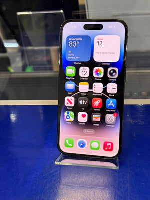 Smartphone with app icons displayed on a reflective surface