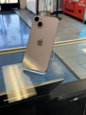 Silver iPhone on a stand with blurred indoor background