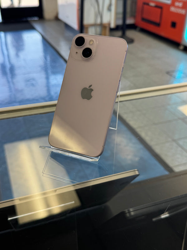 Silver iPhone on a stand with blurred indoor background