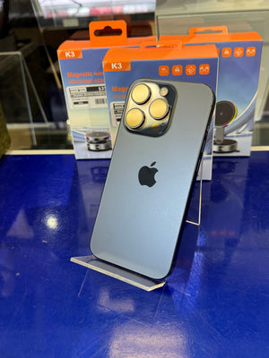 Smartphone with Apple logo on a blue surface, with packaging in the background