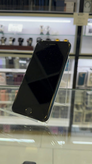 Black smartphone on a stand with a blurred store background