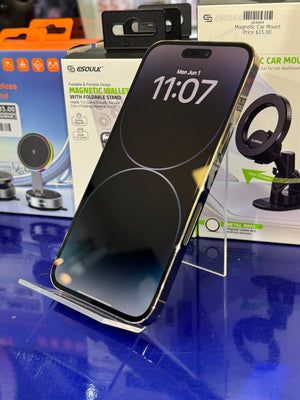 Apple Smartphone on a stand on a blue surface with packaging in the background
