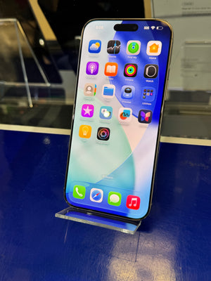 Smartphone with app icons on a stand against a blurred indoor background