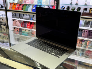 Laptop on display in a store with phone cases in the background