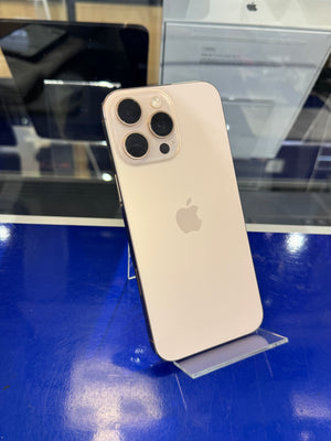 Gold iPhone on a stand with a blue surface and blurred background