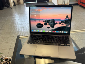 Laptop on a glass table with a scenic wallpaper