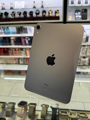 Back view of an iPad with Apple logo on a store shelf background