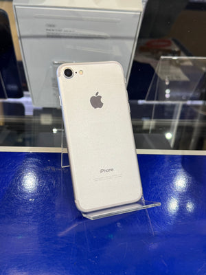 White iPhone on a blue surface with reflections