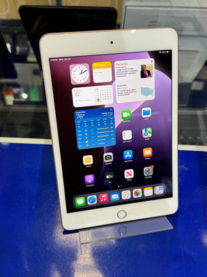 Tablet with app icons on a stand against a blue background