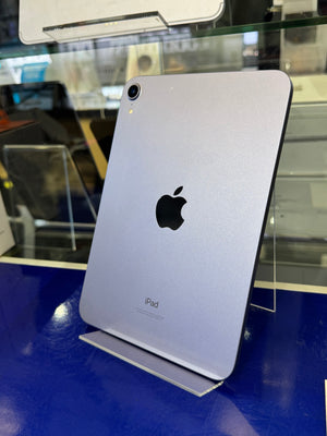 Back view of a silver iPad on display with a blurred background