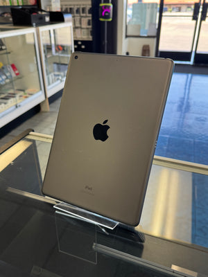 Silver iPad on a stand in a store setting
