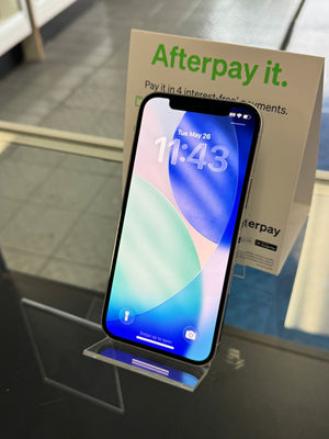 Smartphone with Afterpay promotional material on a stand