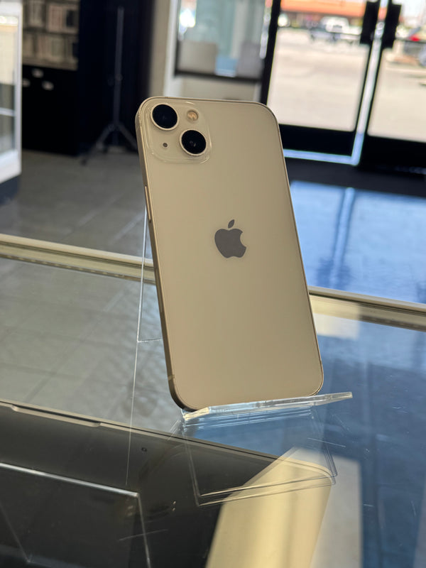 Silver iPhone on a clear stand with blurred background