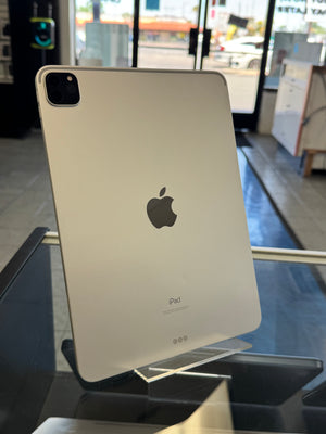Back view of an iPad on display with a blurred indoor background