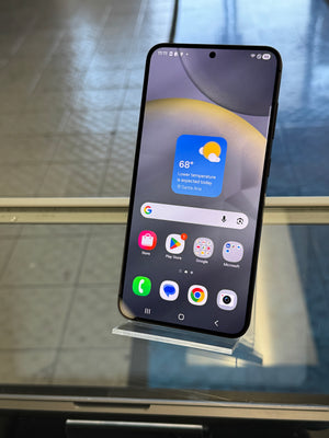 Smartphone on a stand with app icons displayed on a reflective surface