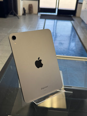 Back view of an iPad Mini on a reflective surface