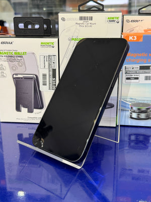 Black smartphone on a stand with packaging in the background
