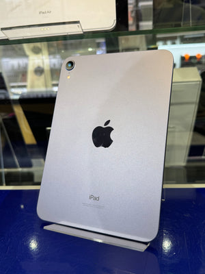 Back view of an iPad on a blue surface with a store setting in the background