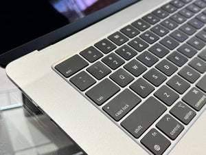 Close-up of a laptop keyboard with a reflective surface