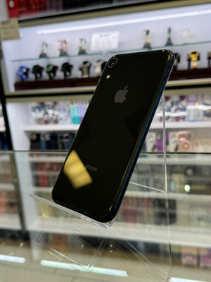 Black smartphone with Apple logo on a reflective surface