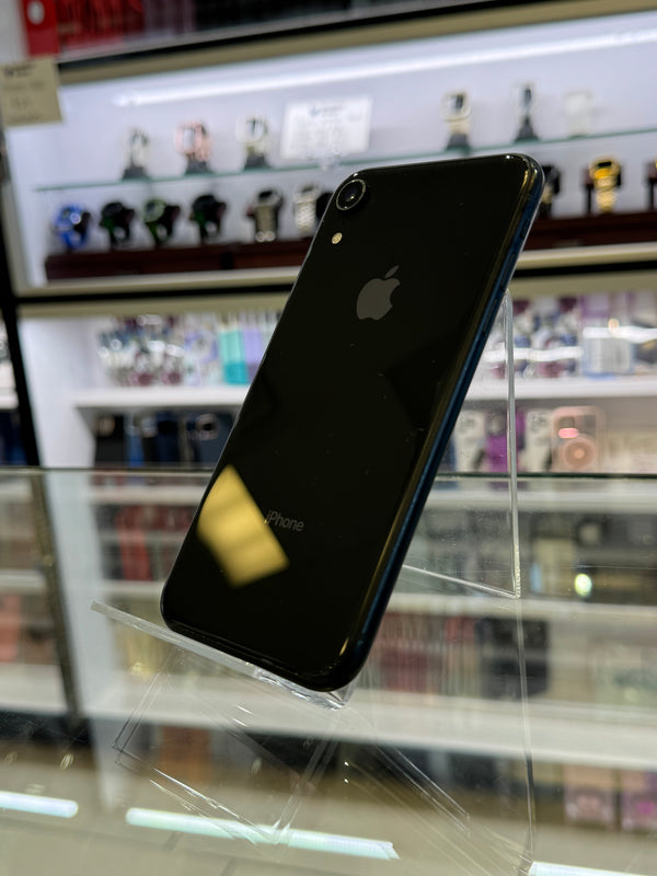 Black smartphone with Apple logo on a reflective surface