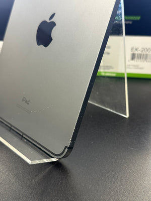 A close-up of the back of a silver Apple iPad pro standing on a clear acrylic display stand, with the Apple logo and 'iPad' text visible.