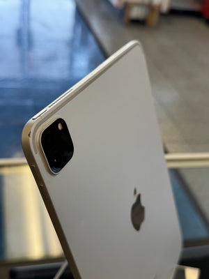 Back view of an Apple smartphone with a blurred indoor background