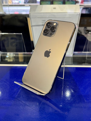 Gold iPhone 12 Pro Max on a stand with blurred store background