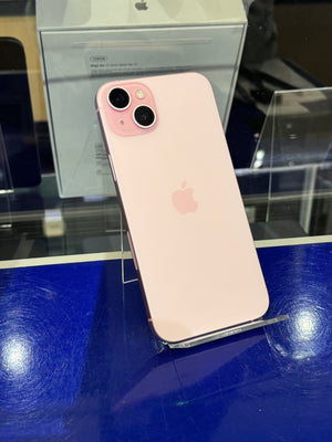 Pink iPhone 11 on a blue surface with blurred background