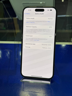 Smartphone displaying battery health information on a reflective surface