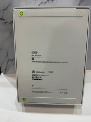 The back of a white Apple iPad box, showing product specifications, barcodes, and regulatory marks, set against a white and gray marble-patterned background.